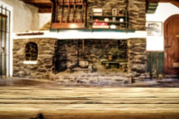 Desk of free space and fireplace in home interior. Wild west background. 