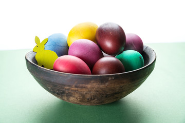 Colorful Easter eggs in bowl. Attribute of Easter celebration.