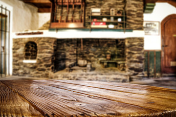 Desk of free space and fireplace in home interior. Wild west background. 