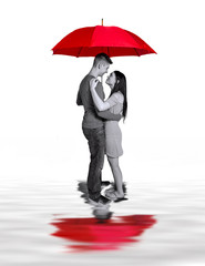 Couple standing under large Red Umbrella with reflections in water.  Concept image, Love Relationship isolated on white background