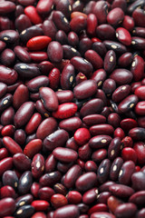 Closeup of a grain of red bean seeds. The texture of the legumes. Close up red beans background, seeds of red beans