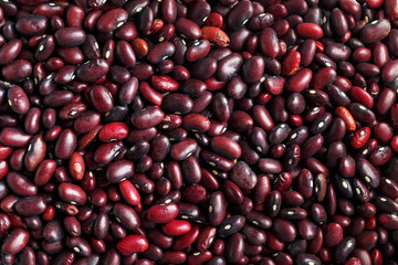 Closeup of a grain of red bean seeds. The texture of the legumes. Close up red beans background, seeds of red beans