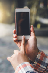 hipster woman using mobile phone touching screen at outdoor with hands typing smart phone texting messaging lifestyle working app device technology internet social data online concept vintage style.