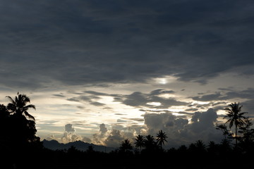 sunset view that emits sunlight against a background of cloudy sky