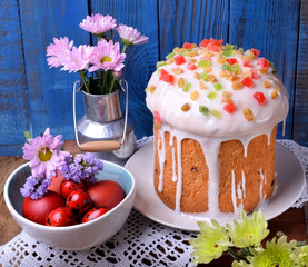 Easter cake topped with sugar glazing and different pieces of candied fruits