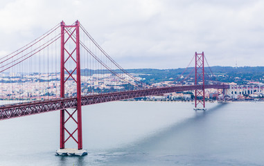 Ponte 25 de Abril Bridge in Lisbon, Portugal. Connects the cities of Lisbon and Almada crossing the Tagus River. View from Almada with Lisbon across