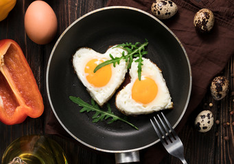 Fried eggs in the form of a heart in a skillet
