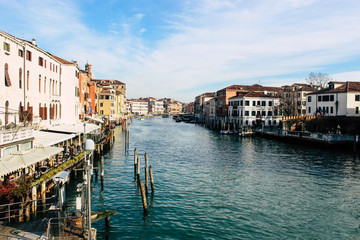 Fototapeta na wymiar Grand Canal in Venice on a sunny day, Italy. Venice in the sunlight. Scenic panoramic view of Venice in winter. Cityscape and landscape of Venice. Romantic water trip.