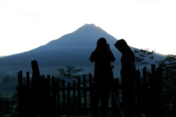 silhouette of a person who is selfie with a mountain background