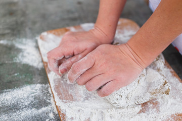 The girl in the woods preparing the dough for the cake