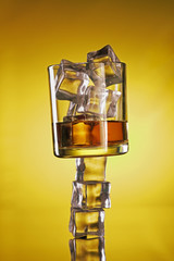 Chilled Whisky Glass on Ice Cubes Creative Shot