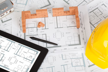Model house construction with brick on blueprint