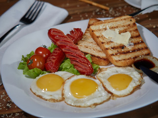 Fried eggs with sausage.