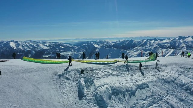 Snowy paragliding in mountains