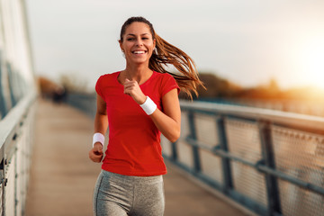 Young  woman jogging outdoors - obrazy, fototapety, plakaty