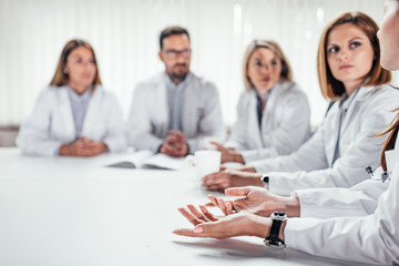 Cropped image of medical team discussing diagnosis.