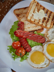 Fried eggs with sausage.