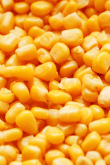 Golden canned corn, as distributed on a plane background and texture of popcorn. Before watching a movie top view. Close-up