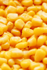 Golden canned corn, as distributed on a plane background and texture of popcorn. Before watching a movie top view. Close-up