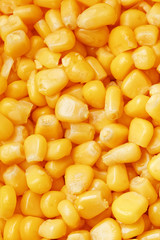 Golden canned corn, as distributed on a plane background and texture of popcorn. Before watching a movie top view. Close-up