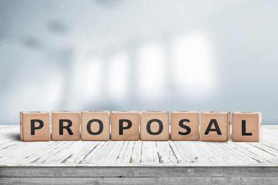 Proposal sign on a wooden desk in a bright office