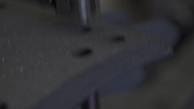 Closeup of a Rivet Machine Punching into a Break Pad