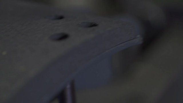 Closeup of a Rivet Machine Punching into a Break Pad