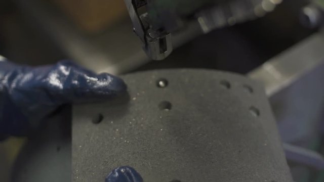 Closeup of a Rivet Machine Punching into a Break Pad