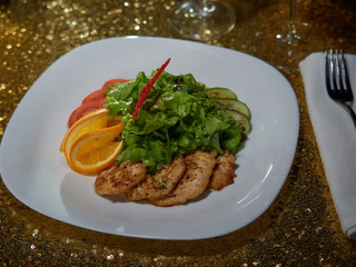 Meat roasted on fire with lemon and green salad.