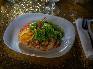 Meat roasted on fire with lemon and green salad.