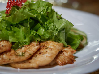 Meat roasted on fire with lemon and green salad.