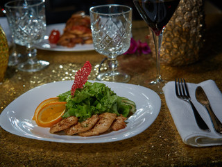 Meat roasted on fire with lemon and green salad.