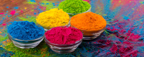 Holi color powder. Organic Gulal colours in bowl for Holi festival, Hindu tradition festive. Bright...