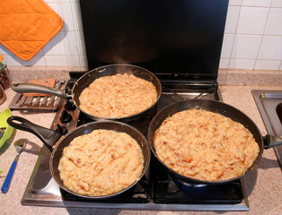 pans with the food named frico a typical italian recipe