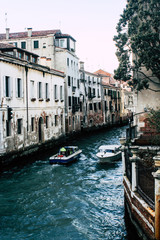 Bridge of Sighs people and tourists on gondola boat passing under the bridge in a sunny summer day in Venice, Italy