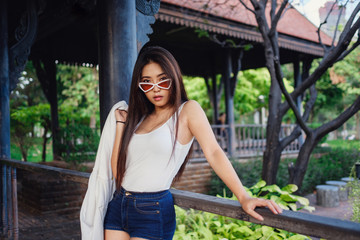 Summer sunny lifestyle fashion portrait of young stylish hipster woman.