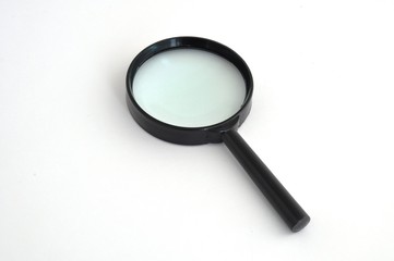 a magnifying glass in a black plastic frame helps to see small objects