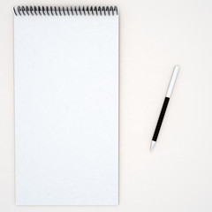 notebook and pen on white background