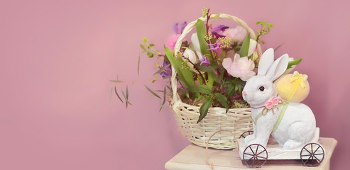 Easter Bunny with eggs and flower basket. Holiday scene with Easter rabbit. beautiful Easter composition, spring season. soft selective focus, copy space