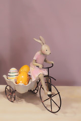 Easter Bunny with eggs on Bicycle. Holiday scene with eggs and Easter rabbit. beautiful Easter composition, spring season. soft focus
