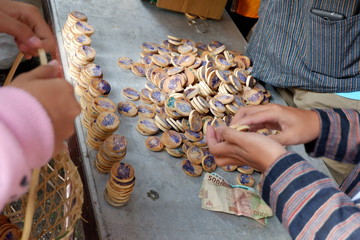 wood money, for sale and purchase transactions at the traditional Merapi mountain market in Magelang, Indonesia