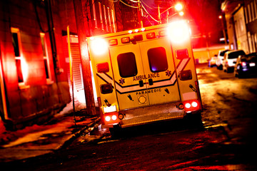 An ambulance car parked on the side street at night