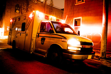 An ambulance car parked on the side street at night © Louis-Paul Photo