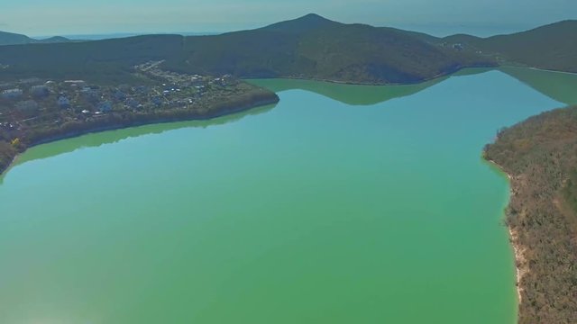 Winery and embankment of Abrau-Durso in summer. The village on the shore Calm, blue sky. Filming with drone. Beautiful futage