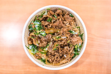 Gyudon or strip beefs with a lots of onion leeks and topped with fresh egg yolk