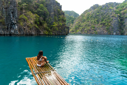 Woman sun bathing on the sea shore, Philippines