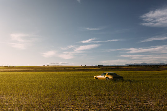 Old yellow sport classic car parked in the countryside
