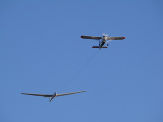 Glider pulled by a motorized plane. Glider airplane stands out flying