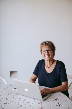 Woman using laptop at table