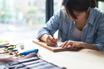 Female carpenter working in studio
